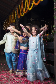 kids playing with rose petals on diwali 