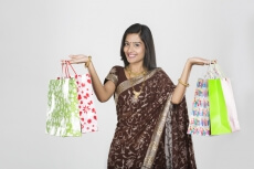 woman in saree with shopping bags 