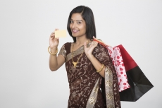 woman in saree with credit card and shopping bags 