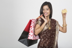 woman in saree with credit card and shopping bags 
