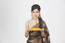 woman in saree with pooja thali 