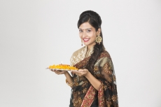 woman in saree with pooja thali 