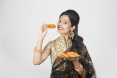 woman in saree with sweets 