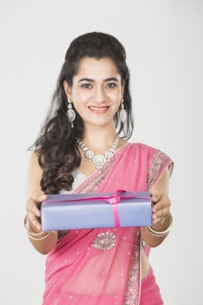 woman in ethnic wear with a gift 