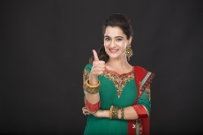 girl posing while showing thumbs up