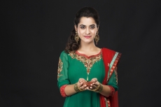 girl posing with diya in traditional wear