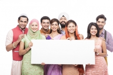 people from all religions standing with a message board