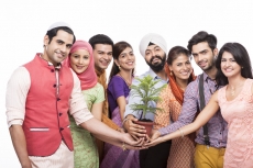 people from all religions posing with a plant 