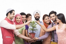 people from all religions posing with a plant 