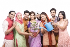 people from all religions giving water to a plant