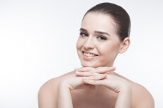 girl smiling and flaunting her perfect skin