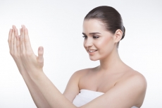 girl with beautiful skin looking at her hands