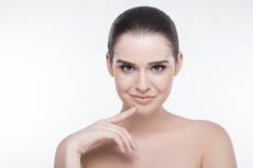 girl with perfect skin looking at the camera while posing