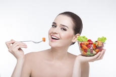 girl posing with a bowl full of salad 