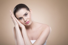 girl with perfect skin looking at the camera while posing