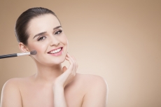 girl posing with make up brush 