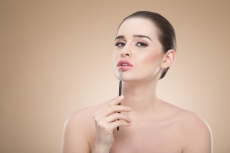 girl applying make up with brush