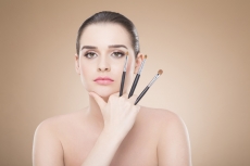 girl posing with make up brush