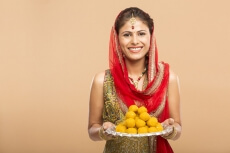 woman posing with laddu