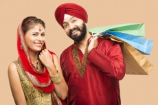 sikh couple posing with gifts and sweets