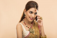 woman in traditional wear talking on phone 
