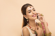woman in traditional wear talking on phone 