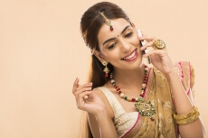 woman in traditional wear talking on phone 