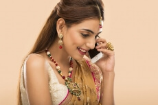 woman in traditional wear talking on phone 
