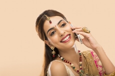 woman in traditional wear talking on phone 