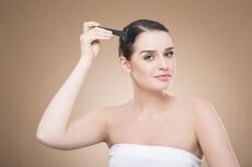 beautiful girl applying hair color