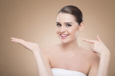girl posing while pointing at hand