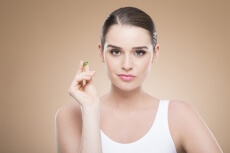 beautiful girl posing with green pill