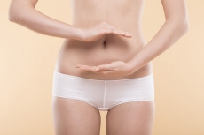 girl make healthcare gesture on her stomach 