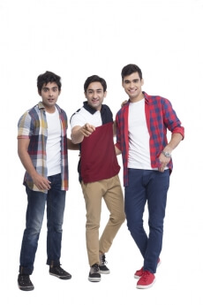 three boys smiling and posing 