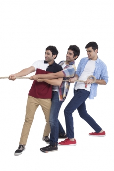 three friends pulling rope