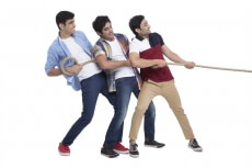 three friends pulling rope