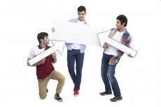 three friends posing with placard