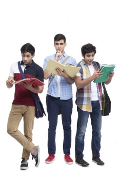 three college friends posing with assignments