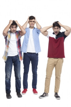 three boys grabbing their head