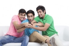 friends fighting for television remote