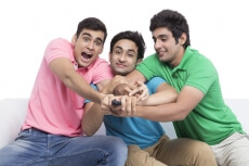 friends fighting for television remote