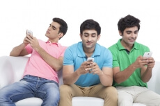 three friends messaging on mobile phone