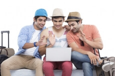 friends on vacation checking with laptop