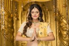 woman in traditional wear doing namaste 