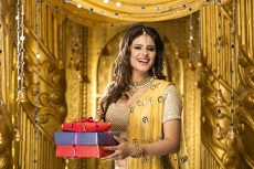 woman in traditional wear with gifts 