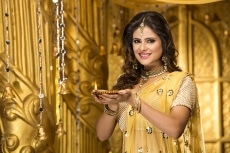 woman in traditional wear with diya 