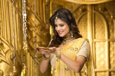 woman in traditional wear with diya 