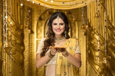 woman in traditional wear with diya 