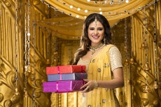 woman in traditional wear with gifts 