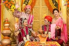 bride and groom with parents at mandap